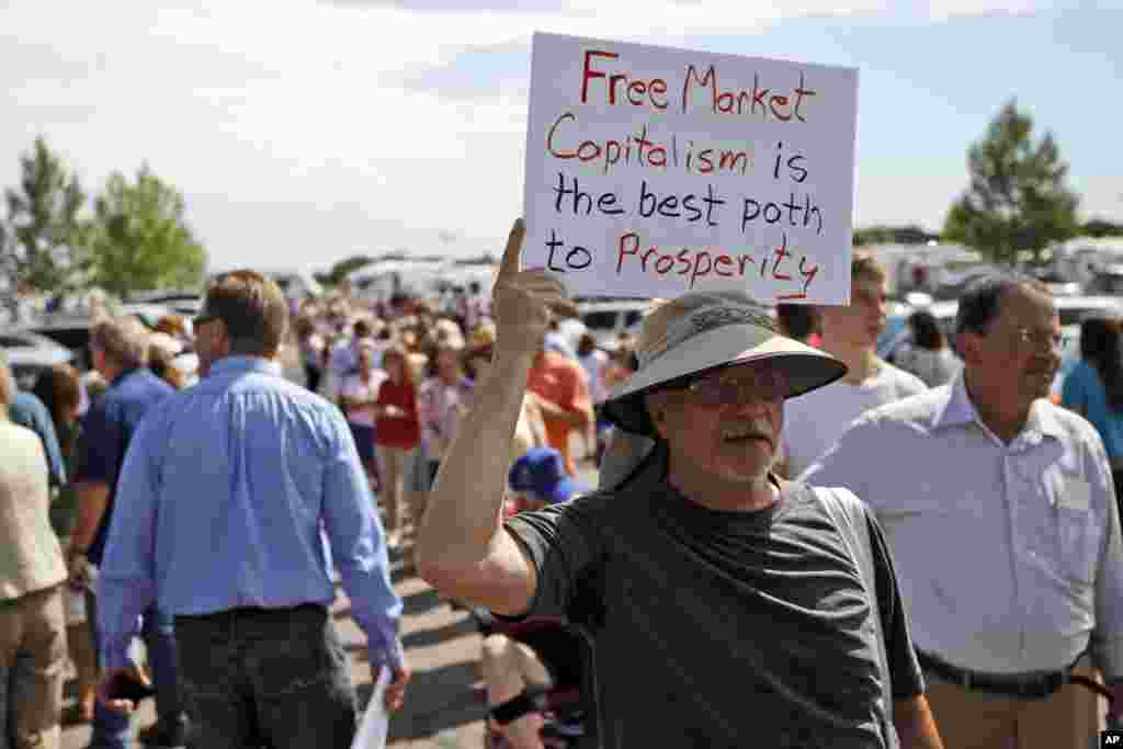 Ned Heitz, from Denver, and a supporter of Republican presidential candidate Mitt Romney, lines up to get into a campaign event at the Jefferson County Fairgrounds in Golden, Colorado, Aug. 2, 2012.
