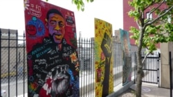 Community members painted murals of George Floyd and Breonna Taylor at the Clayton Jackson McGhie Memorial in Duluth, Minnesota. (M. Young/VOA)