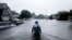 A member of the North Carolina Task Force urban search and rescue team wades through a flooded neighborhood looking for residents who stayed behind as Florence continues to dump heavy rain in Fayetteville, N.C., Sunday, Sept. 16, 2018.