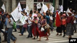 FILE - Hundreds of indigenous people, peasant farmers and activists demonstrate in the streets of Guatemala City, demanding the end of the corruption and the persecution of political leaders, May 8, 2019. 