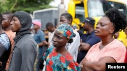 People watch rescue operations after an under-construction building collapsed in Oniru, Lagos