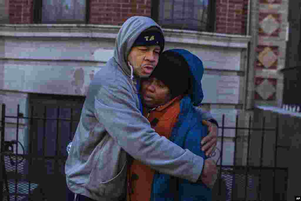 Emelia Ascheampong, a resident of the building where more than 10 people died in a fire on Thursday, is hugged by a friend in the Bronx borough of New York.&nbsp;