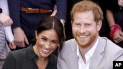 FILE - In this file photo dated Wednesday Oct. 3, 2018, Meghan, Duchess of Sussex and Britain's Prince Harry, make an official visit to the Joff Youth Centre in Peacehaven, Britain. Kensington Palace announced Monday Oct. 15, 2018, that Prince Harry and 