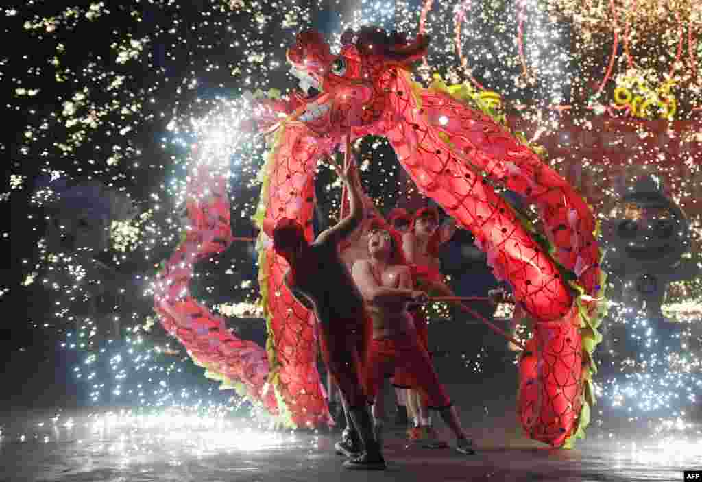 Dragon dancers perform at a park in Beijing, China on the fourth day of the Lunar New Year.