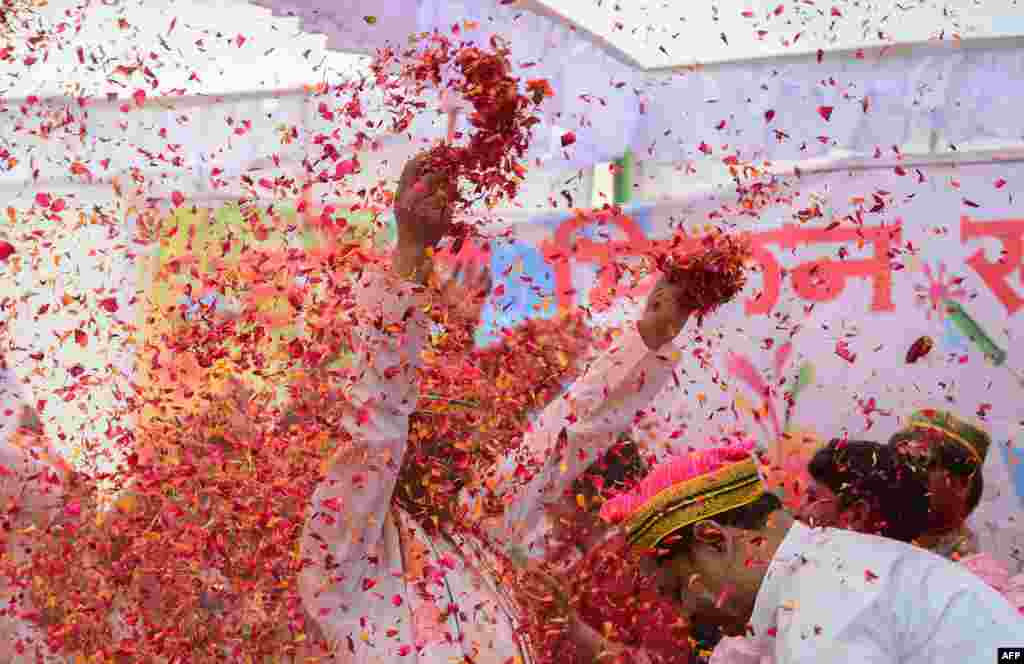 Flower petals and colored powder are thrown around at an event to celebrate the Hindu festival of Holi for children with cerebral palsy organized by the Trishla Foundation in Allahabad, India.