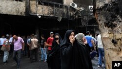 Iraqi women wait to hear about family members who went missing after a truck bomb hit Karrada, a busy shopping district in the center of Baghdad, Iraq, July 3, 2016. 