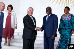 U.S. Secretary of State Rex Tillerson shakes hands with African Union (AU) Commission Chairman Moussa Faki, of Chad, after their meeting at African Union headquarters, Thursday, March 8, 2018 in Addis Ababa, Ethiopia.