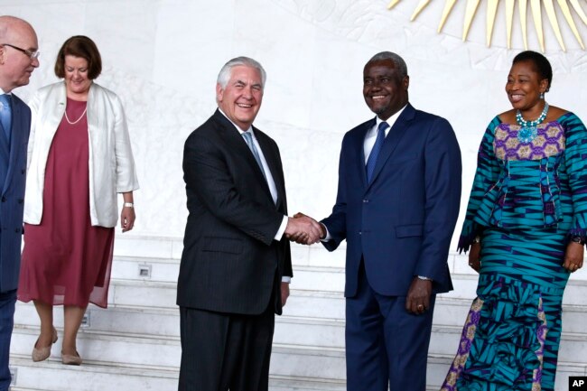 U.S. Secretary of State Rex Tillerson shakes hands with African Union (AU) Commission Chairman Moussa Faki, of Chad, after their meeting at African Union headquarters, Thursday, March 8, 2018 in Addis Ababa, Ethiopia.