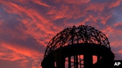 FILE - In this Aug. 5, 2013, photo, the Atomic Bomb Dome is silhouetted at sunset in Hiroshima, western Japan. 