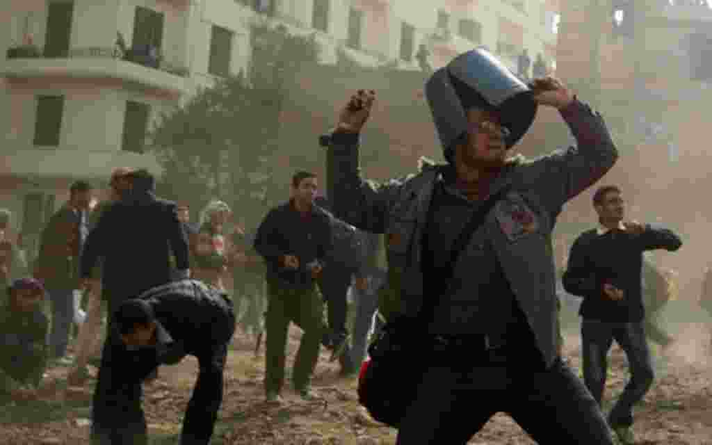 An opposition demonstrator throws a rock during clashes with supporters of President Hosni Mubarak Thursday near Tahrir Square in Cairo