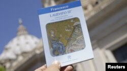 Pope Francis' new encyclical titled "Laudato Si (Be Praised), On the Care of Our Common Home", is displayed during the presentation news conference at the Vatican, June 18, 2015.