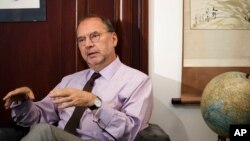 In this Oct. 17, 2014 photo, Dr. Peter Piot, Director of the London School of Hygiene and Tropical Medicine and co-discoverer of the Ebola virus, speaks with The Associated Press at his office in London. 