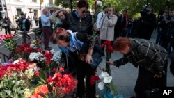 People lay flowers as they gather to commemorate the five-year anniversary of deadly clashes which killed dozens of demonstrators supporting Ukraine's government and pro-Russia protesters, in Odessa, Ukraine, May 2, 2019.