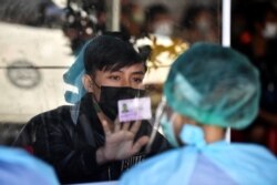 A migrant worker registers with a migrant worker ID at a Covid-19 coronavirus mobile testing clinic in Pathum Thani, just north of Bangkok on January 10, 2021.