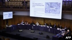 The panel is shown images of what witnesses say are re-education camps in China on the first day of hearings at the "Uyghur Tribunal", a panel of UK-based lawyers and rights experts investigating alleged abuses in China, in London on June 4, 2021.