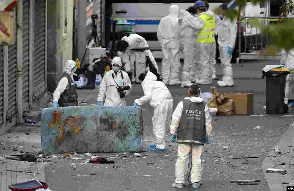 Forensic units of the French police search for evidences outside a building in the northern Paris suburb of Saint-Denis.