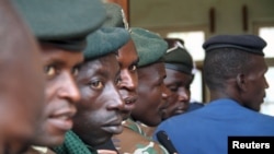 Members of the Burundi military wait at a polling station during a parliamentary election near Burundi's capital Bujumbura, June 29, 2015.