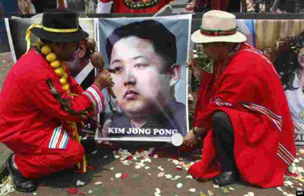 Shamans perform a ritual for good luck in 2012 as they hold up a poster of North Korea's next leader Kim Jong Un in Lima, Peru, Thursday Dec. 29, 2011. (AP Photo/Karel Navarro)