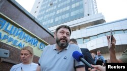 Kirill Vyshinsky, director of the Ukrainian office of the Russian state news agency RIA Novosti, who was detained on treason charges in 2018, talks to the media after a court ordered his release on bail, in Kyiv, Ukraine, Aug. 28, 2019. 