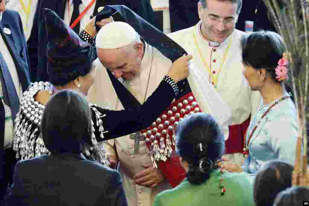 Pope Francis is greeted as he arrives for a meeting with Myanmar leader Aung San Suu Kyi, at the International Convention Center of Naypyitaw, Nov. 28, 2017.