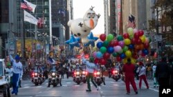 The Olaf balloon floats down Sixth Avenue during the Thanksgiving Day parade in New York, Nov. 23, 2017. 