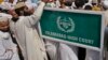 FILE - Men are seen outside the Islamabad High Court, Oct. 11, 2011, in Islamabad, Pakistan. The court this week temporarily barred the extradition of Talha Haroon, 19, wanted by American authorities in connection with allegedly hatching a terror plot. 