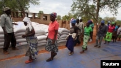 FILE: Villagers collect their monthly food ration provided by the United Nations World Food Program (WFP) in Masvingo, Zimbabwe.