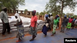 Villagers collect their monthly food ration provided by the United Nations World Food Program (WFP) in Masvingo, Zimbabwe, Jan. 25, 2016.