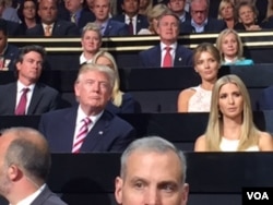 Donald Trump and his daughter Ivanka listen to Eric Trump's speech at the Republican National Convention, in Cleveland, July 20, 2016.