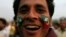 A supporter of the political party Pakistan Tehreek-e- Insaf (PTI) with party flags painted on his face attends a rally in Lahore, March 23, 2013.