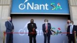 South African President Cyril Ramaphosa (C-L) and South African-born American billionaire Patrick Soon-Shiong cut the ribbon during the launch of NantSA, a future vaccine manufacturing facility, in Cape Town, South Africa, Jan. 19, 2022. 
