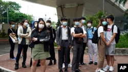 FILE: Young supporters of the former Studentlocalism leader Tony Chung wait outside a court, in Hong Kong, Oct. 29, 2020.