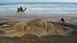 Sand artist Sudarshan Pattnaik works on a sculpture about Cyclone Phailin that hit Puri in the eastern Indian state of Odisha.