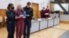 FILE - One of five members of the "United Patriots" group arrives for the start of their trial in a Koblenz courtroom, Germany, May 17, 2023 (defendant's face blurred at source due to German privacy laws).