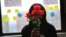A survivor of sexual assault holds plastic flowers after attending a meeting with the group "Sisters in Strength" in the Brooklyn borough of New York, March 14, 2019. 