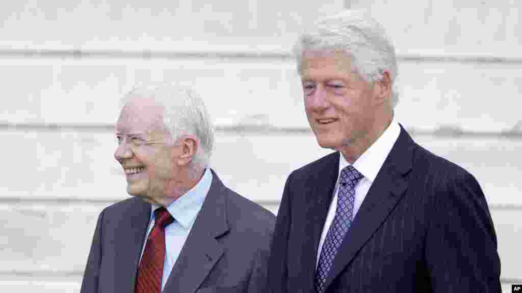 Former presidents Jimmy Carter and Bill Clinton arrive at the Let Freedom Ring ceremony at the Lincoln Memorial in Washington, Aug. 28, 2013. 
