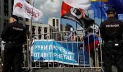 FILE - People hold a banner reading "Hands off the Internet" during a rally in protest against court decision to block the Telegram messenger because it violated Russian regulations, in Moscow, Russia, May 13, 2018.