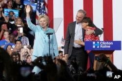 FILE - Sen. Tim Kaine, D-Va., hugs his wife Anne Holton during a with Democratic presidential candidate Hillary Clinton at Florida International University Panther Arena in Miami, Saturday, July 23, 2016.