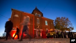 FILE - Guests arrive at the The Dent Schoolhouse haunted attraction, Thursday, Oct. 29, 2015, in Cincinnati. (AP Photo/John Minchillo)