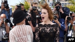 US actresses Parker Posey (L) and Emma Stone pose during a photocall for the film "Irrational Man" at the 68th Cannes Film Festival in Cannes, southeastern France, on May 15, 2015.