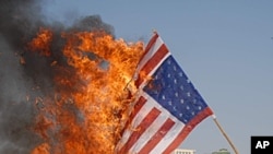 Pakistani protesters burn representation of U.S. flag at a rally to condemn drone attacks on militants allegedly hiding in Pakistan tribal areas, in Multan, Pakistan, (File January 11, 2012).