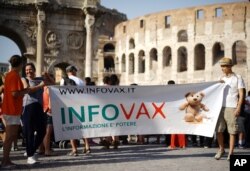 FILE - People rally for freedom of choice in deciding whether or not to vaccinate their children, in downtown Rome, Italy, July 22, 2017.