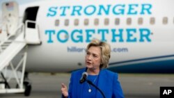 Democratic presidential candidate Hillary Clinton speaks to members of the media before boarding her campaign plane at Westchester County Airport in White Plains, New York, Sept. 8, 2016, to travel to a campaign rally in Charlotte, North Carolina.