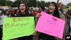 LGBT activists shout slogans during a rally against a planned revision to Indonesia's criminal code, outside the Parliament in Jakarta, Indonesia, Feb. 12, 2018. 