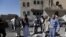 Yemeni Huthis gather around the body of a man killed by air strikes at a detention centre in the capital Sanaa on Dec. 13, 2017.