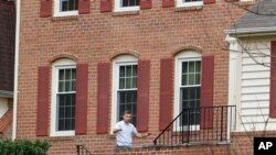 Ruslan Tsarni, the uncle of the Boston Marathon bombing suspects, walks into his home in Maryland.