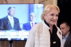 FILE - Former Romanian Prime Minister Viorica Dancila smiles after exit polls show her as the runner-up in the first round of presidential elections, in Bucharest, Romania, Nov. 10, 2019.