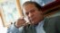 Nawaz Sharif, the leader of Pakistan Muslim League - Nawaz (PML-N) points as he speaks to foreign reporters at his residence in Lahore, May 13, 2013. 