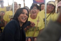 Democratic presidential candidate Sen. Kamala Harris, D-Calif., casts a straw poll vote for herself at the Charleston Blue Jamboree on Saturday, Oct. 5, 2019, in North Charleston, S.C. (AP Photo/Meg Kinnard)