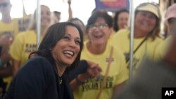 Democratic presidential candidate Sen. Kamala Harris, D-Calif., casts a straw poll vote for herself at the Charleston Blue Jamboree, Oct. 5, 2019, in North Charleston, S.C.